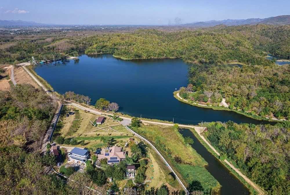 The Best Feng Shui House For Sale, surrounded by reservoir and mountains.