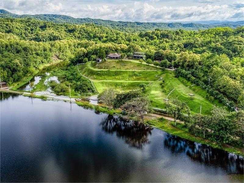 The Best Feng Shui House For Sale, surrounded by reservoir and mountains.